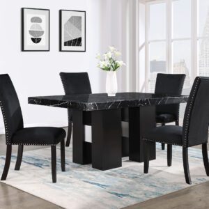 A dining room table with black chairs and white walls